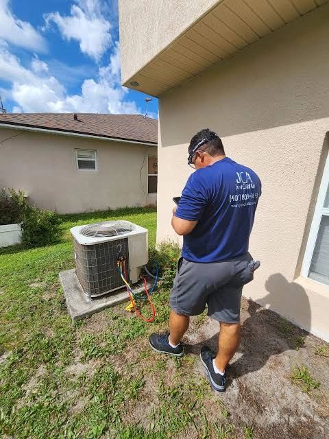 JCA technician checking AC unit