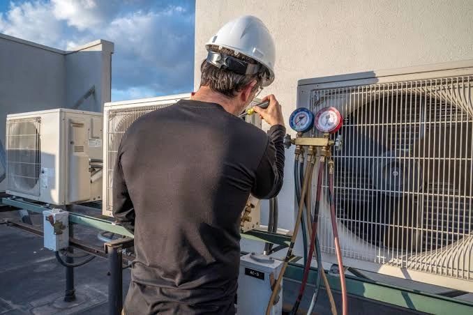 HVAC technician servicing rooftop units